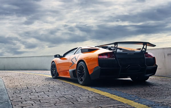 Обои lamborghini, orange, тучи, murcielago, ограждение, оранжевый, ламборгини, задок, мурсиэлаго, lp670-4 SV, небо, брусчатка